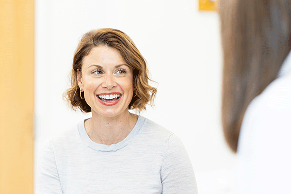 Patient talking with healthcare provider in a clinical setting.