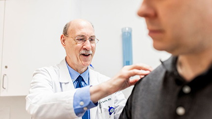 Rheumatologist examining patient