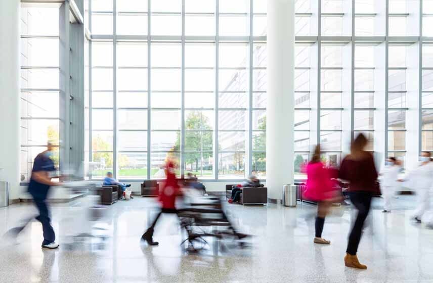People walking through the lobby of a hospital